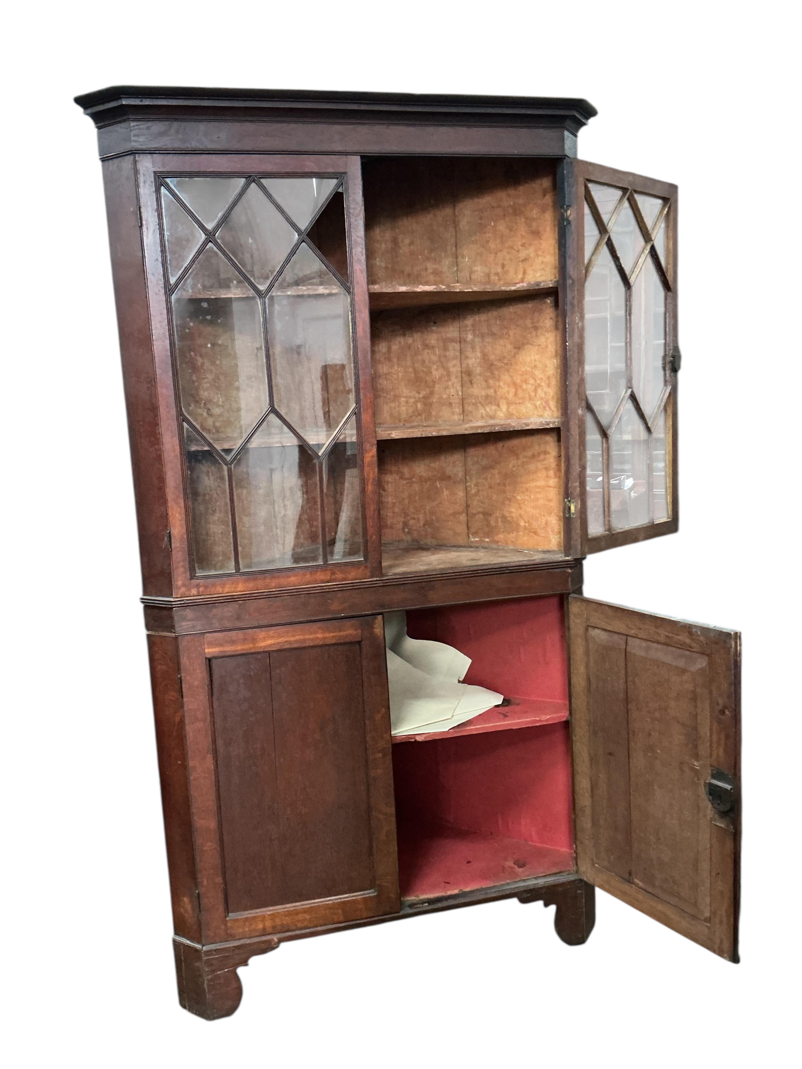 A George III oak standing corner cupboard (one glass panel missing), width 104cm, depth 57cm, height 200cm